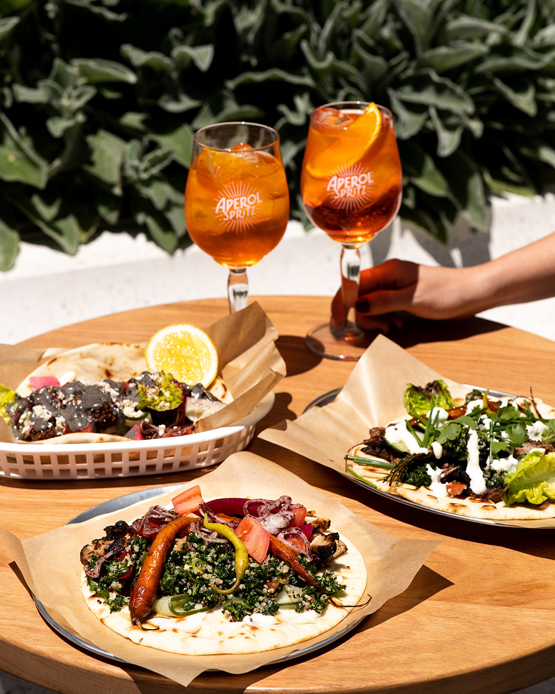 Aperol Spritz and Mediterranean dishes on a table at Casa Aperol Bondi 