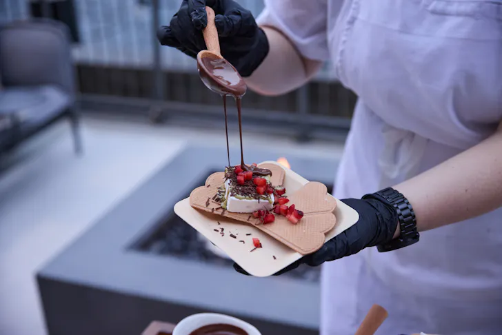 a person holding a chocolate dessert