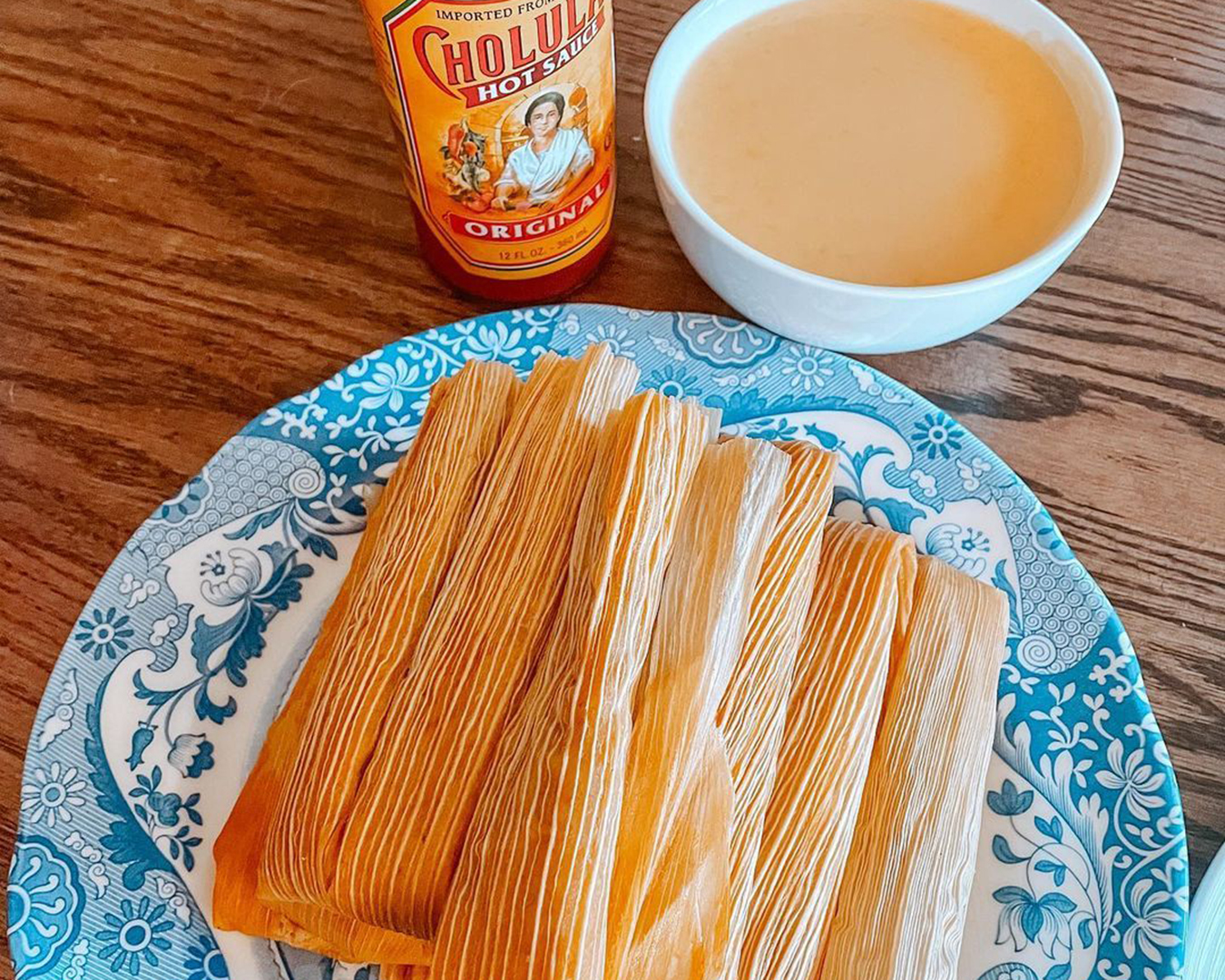 Tamales with Cholula Hot Sauce in the background