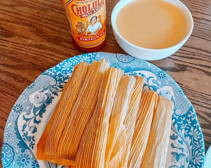 Tamales with Cholula Hot Sauce in the background