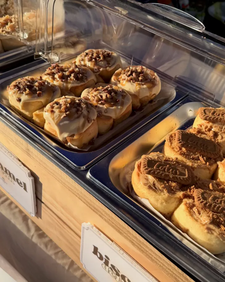 Rows of Biscoff and caramel scrolls on a market table