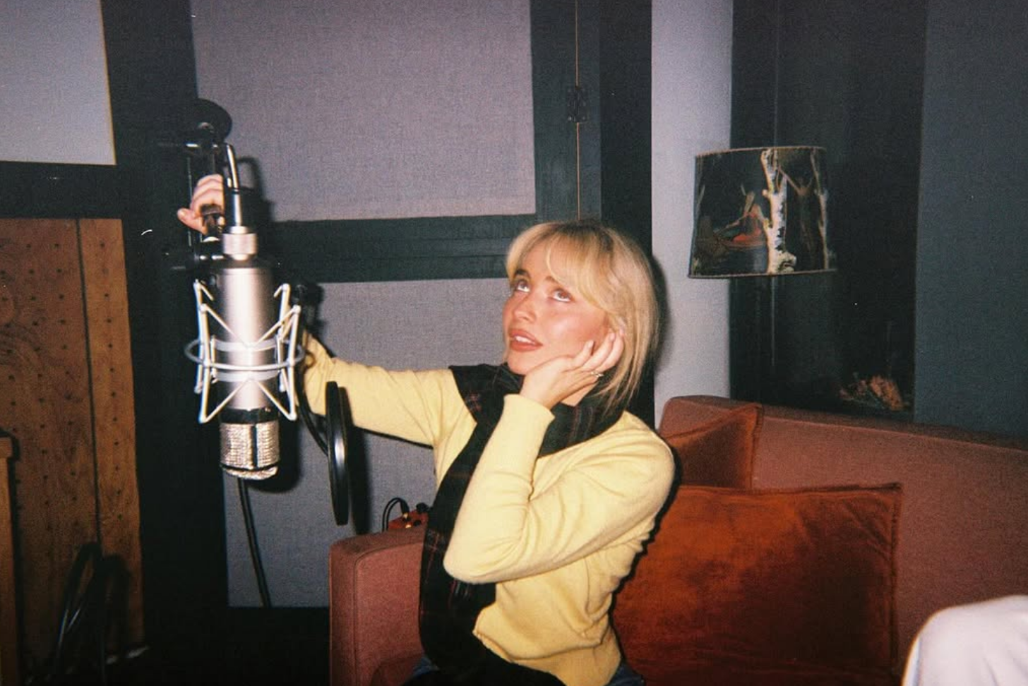 a person recording themselves singing in a room