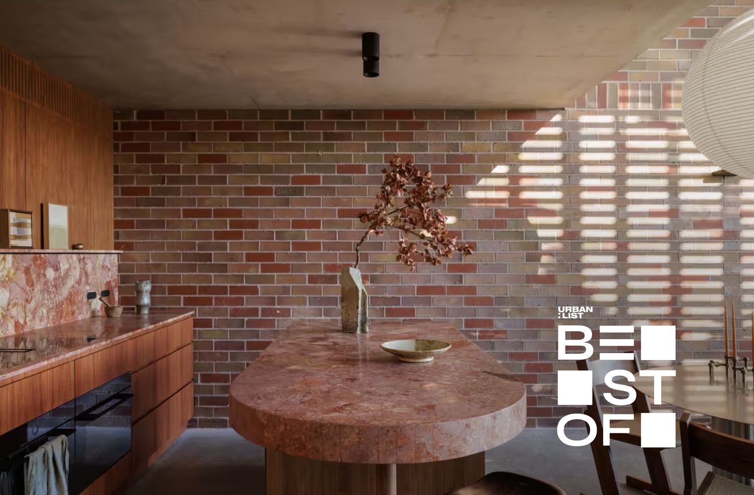 a modern kitchen with a rice paper lamp hanging from the ceiling