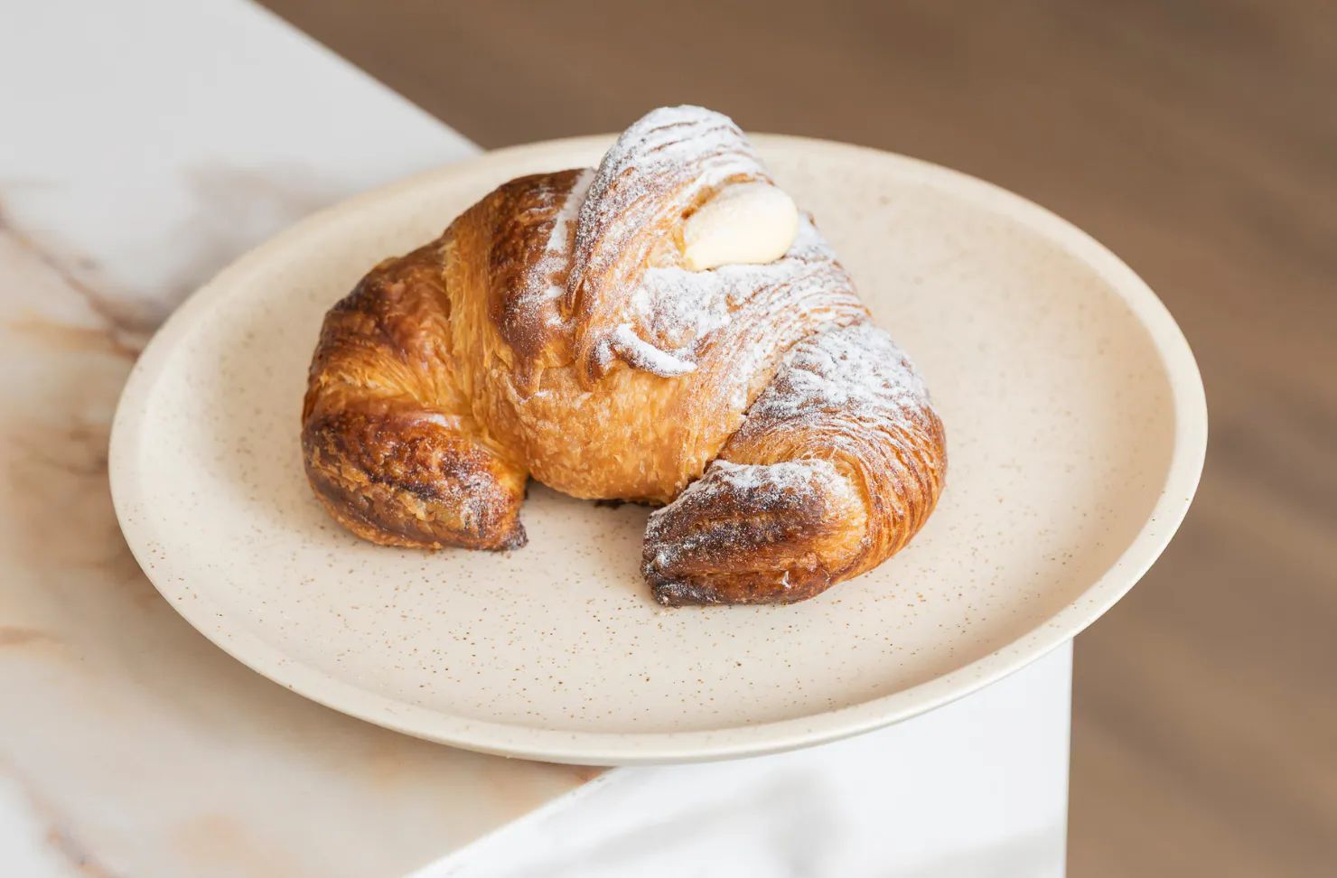 a cornetto pastry on a plate