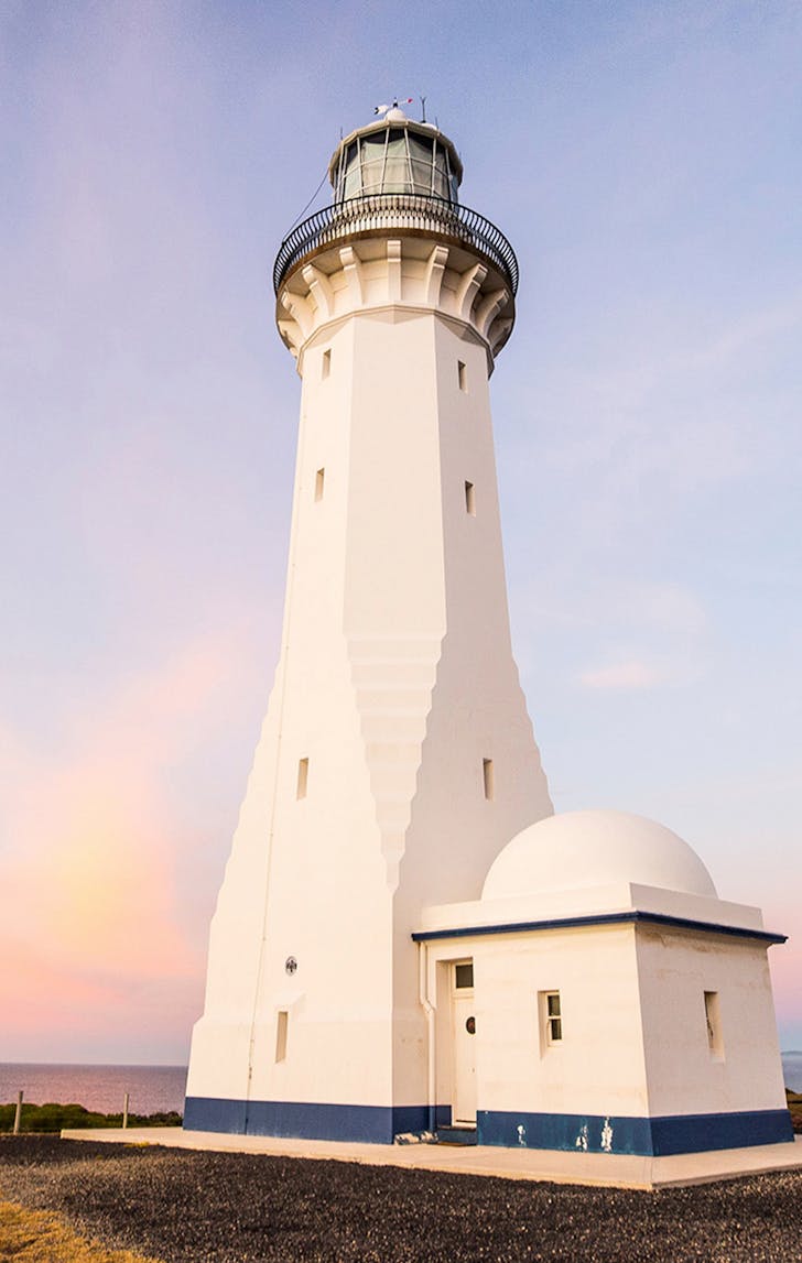purple sunset overlooking headline at green cape lighthouse
