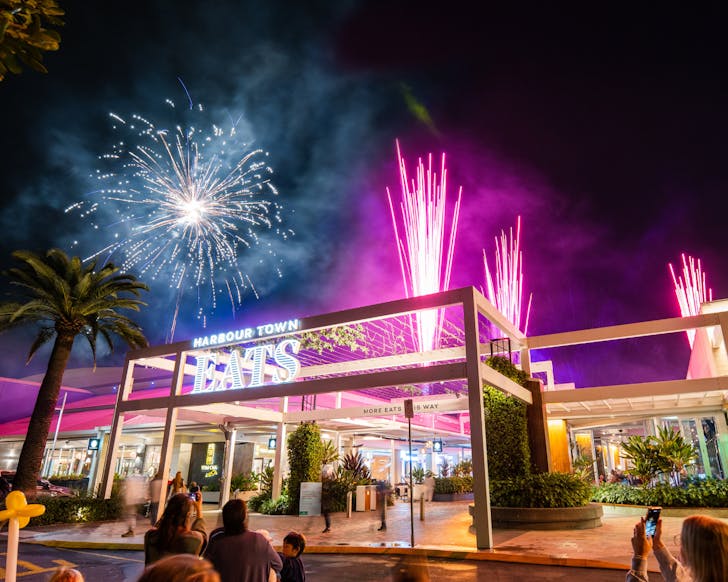 Multi-coloured fireworks lighting up the night sky above the Harbour Town sign.