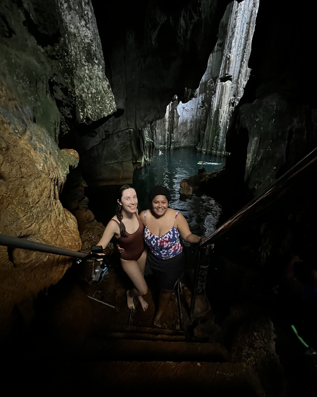 two people standing on the stairs leading to Sawa I Lau Caves - Tourism Fiji