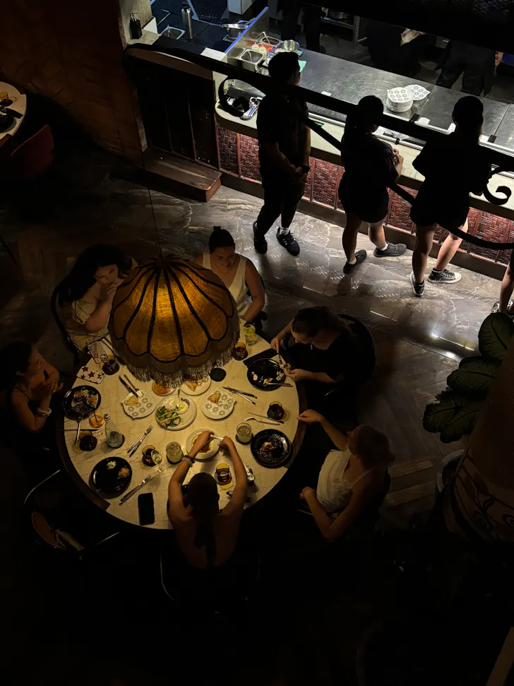 top-down of people eating at a circular table in a restaurant