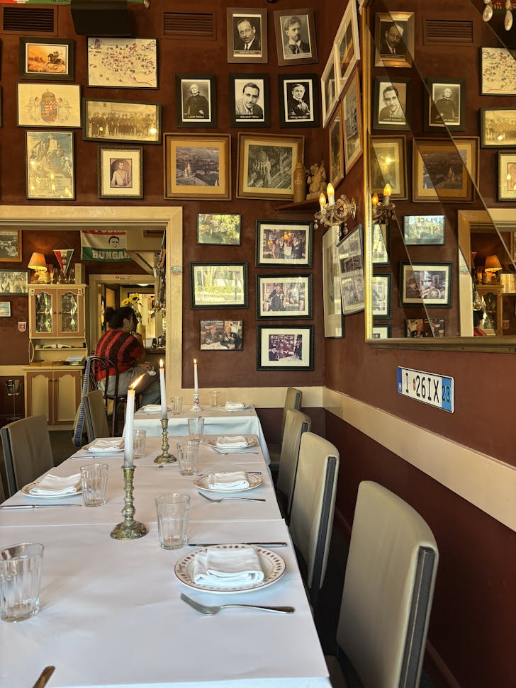 a restaurant dining room with hungarian memorabilia