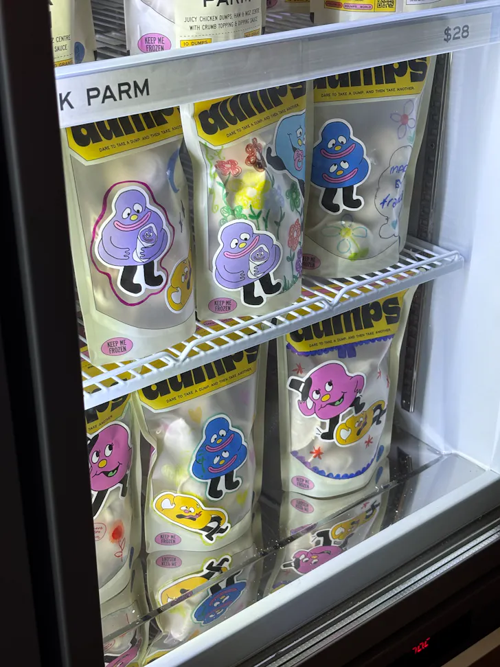frozen dumplings in colourful packets in a freezer