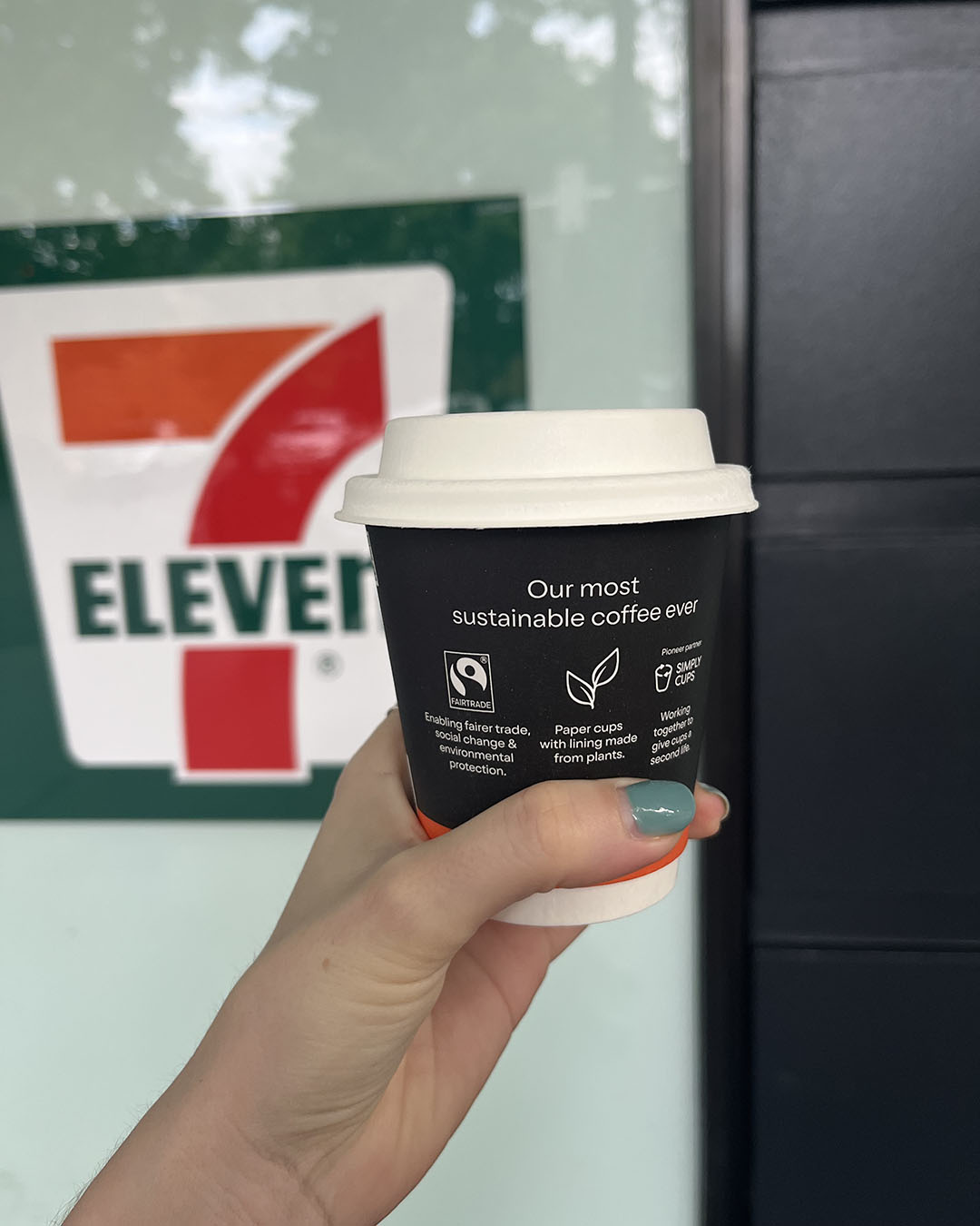 someone holding 7-Eleven fairtrade coffee