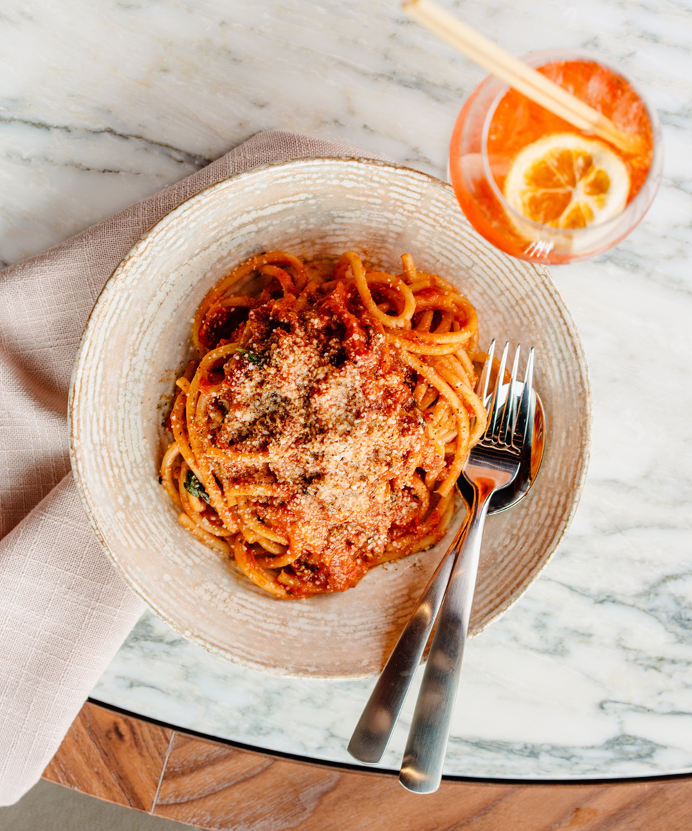 a bowl of pasta and an aperol spritz at iTL Kitchen