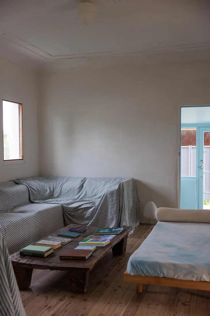 a modular sofa with a coffee table covered in books