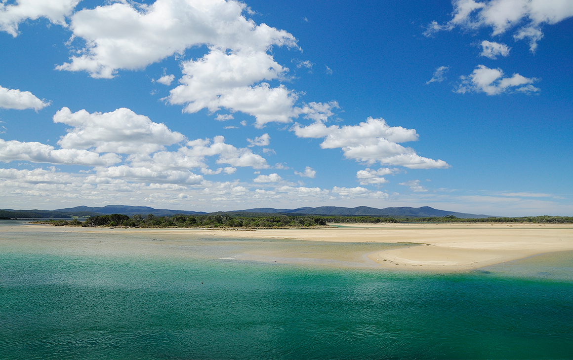 Sparkling blue-green water meets the sandy beach of Mallacoota