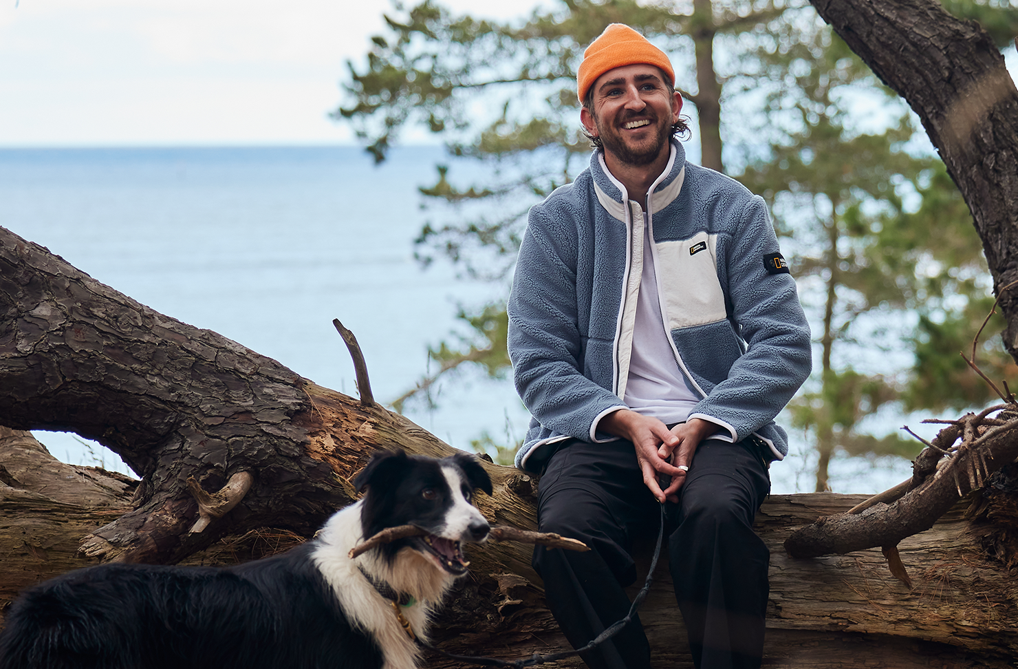 Man sitting with his dog outdoors in the Mornington Peninsula. 