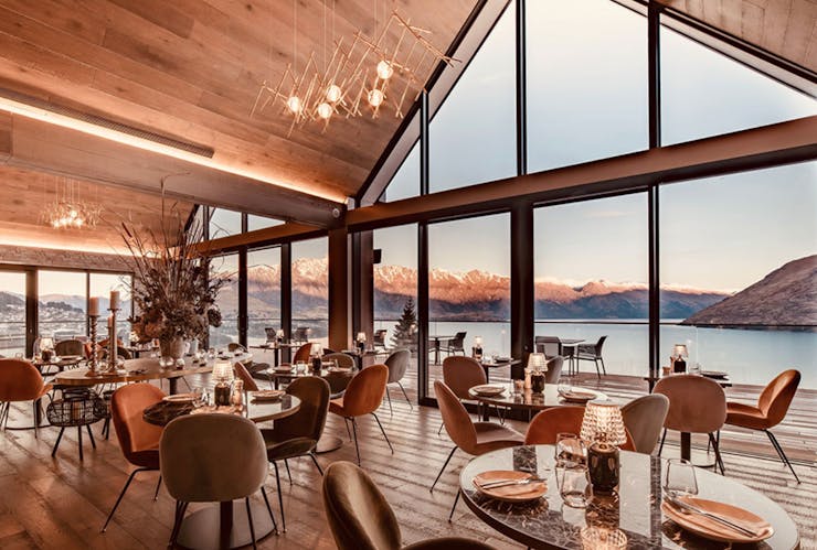 tables and chairs look out over a lake