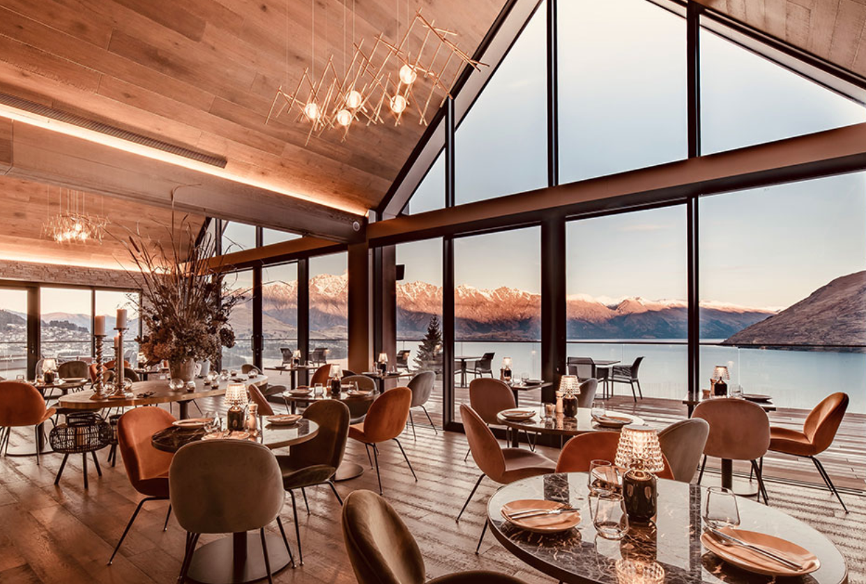 tables and chairs look out over a lake