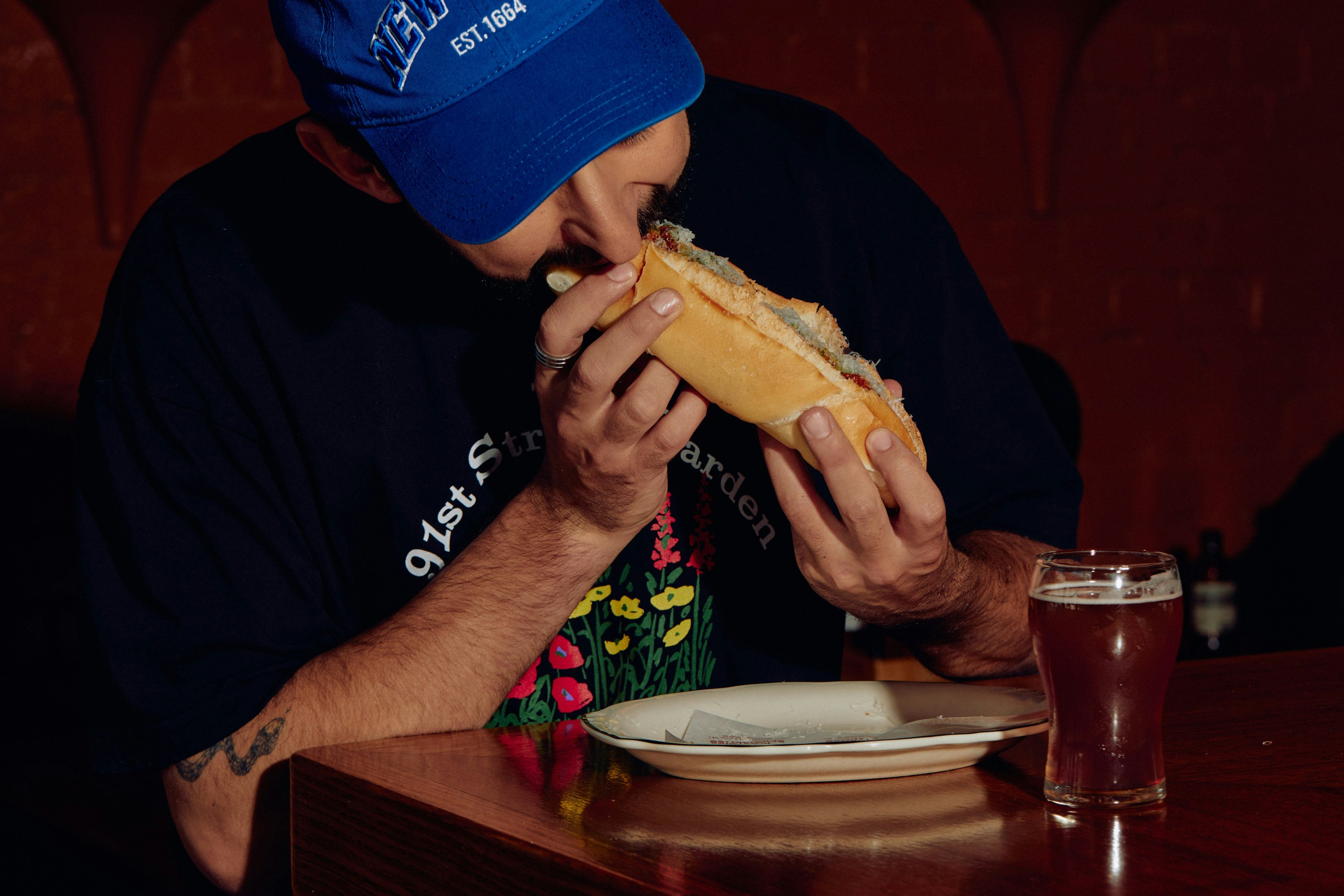 Person eating a sandwich at a Melbourne restaurant.