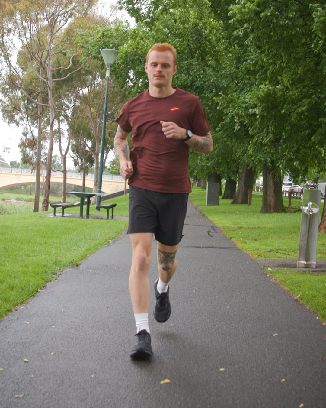 George Wintle running in the park in Brooks shoes and apparel 