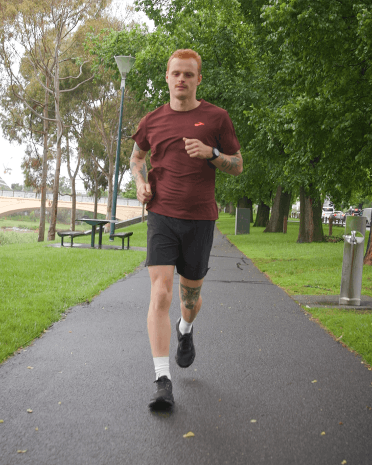 George Wintle running in the park in Brooks shoes and apparel 