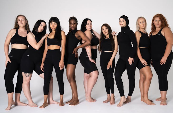 diverse group of girls posing in black activewear