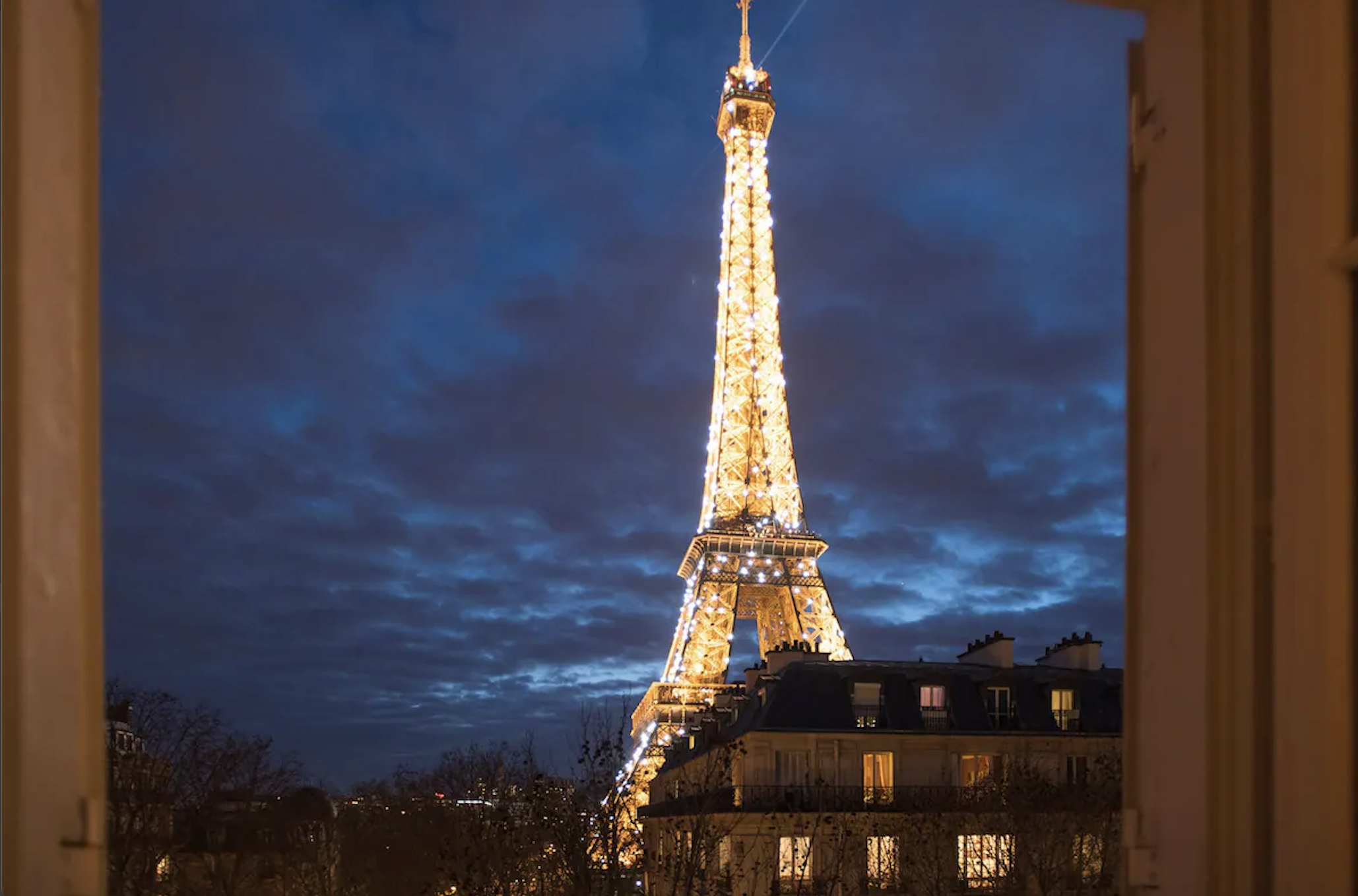 The Bergerac Paris view of the Eiffel Tower sparkling at night