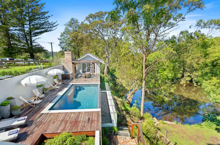 property with a large pool in bushland on a sunny day