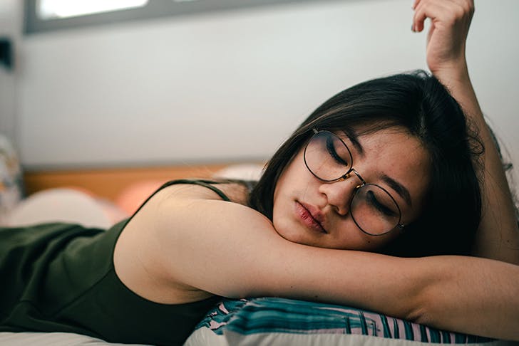 Girl sleeping with glasses on. 