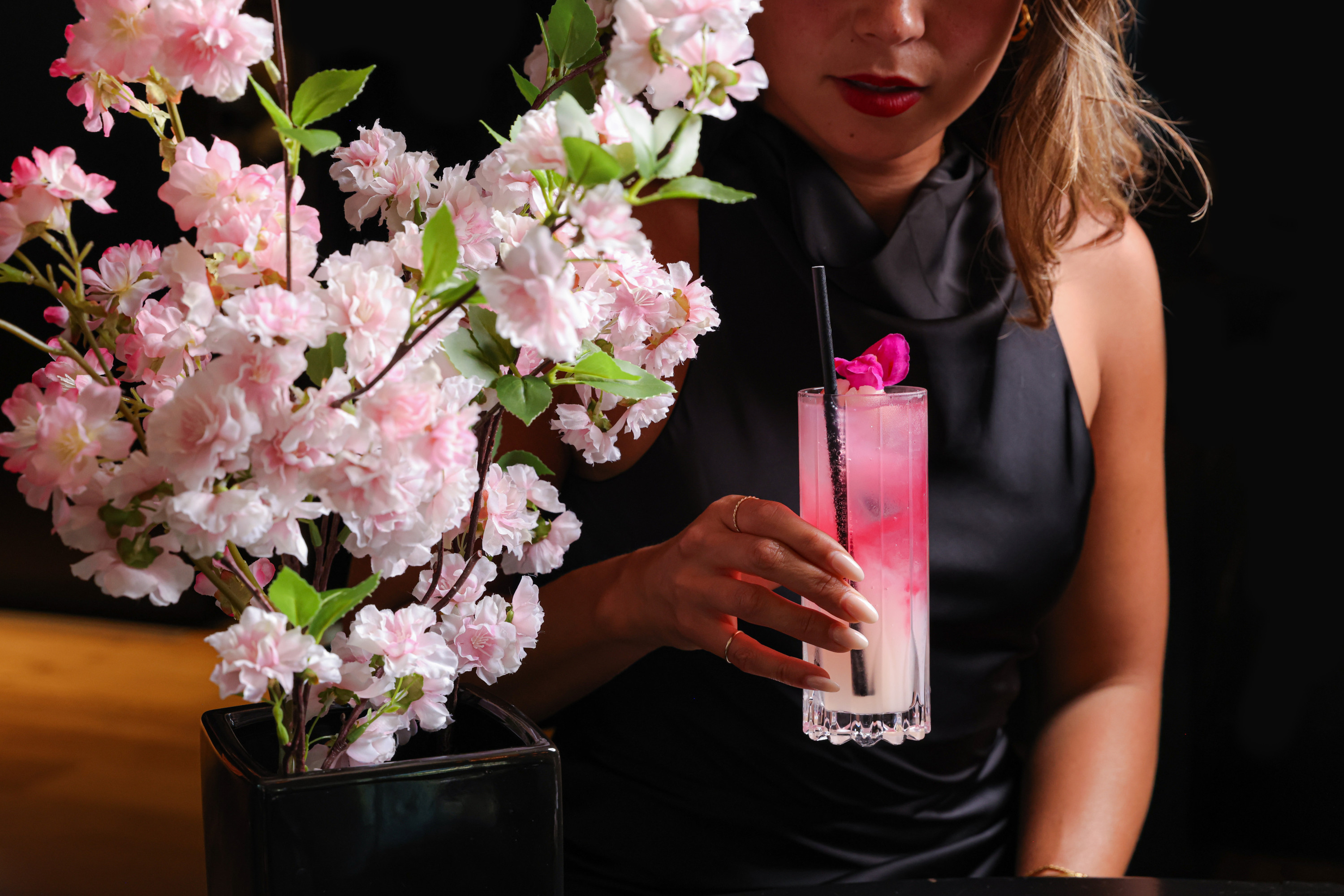 Sokyo Afterdark with a woman holding a japanese-inspired cocktail