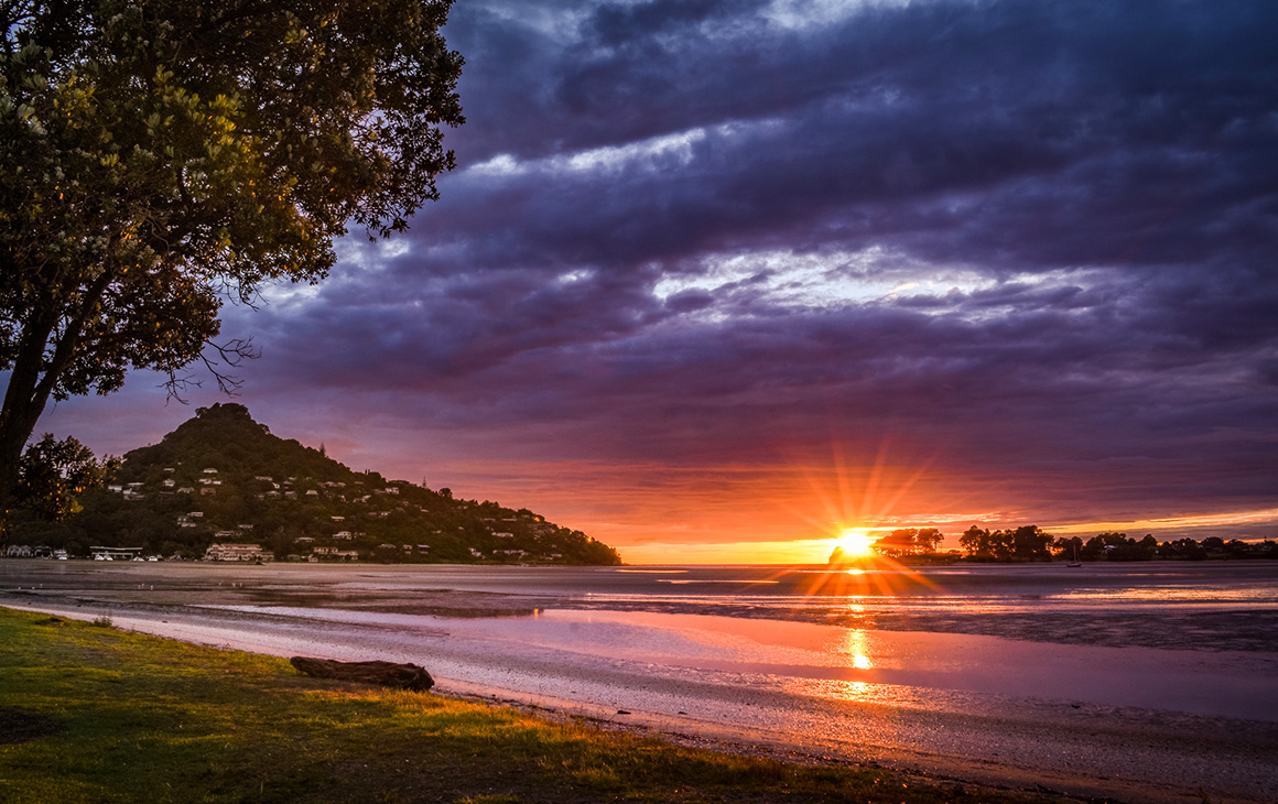 The sun goes down over Tairua Ocean Beach.