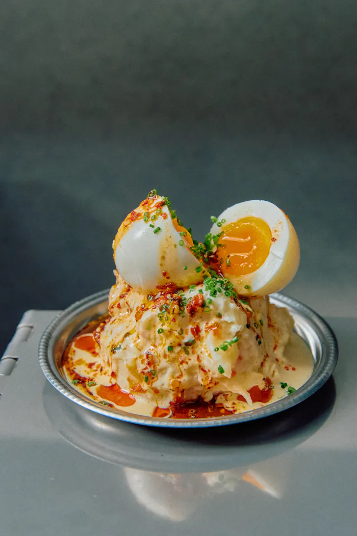 an egg dish with sauce dripping over