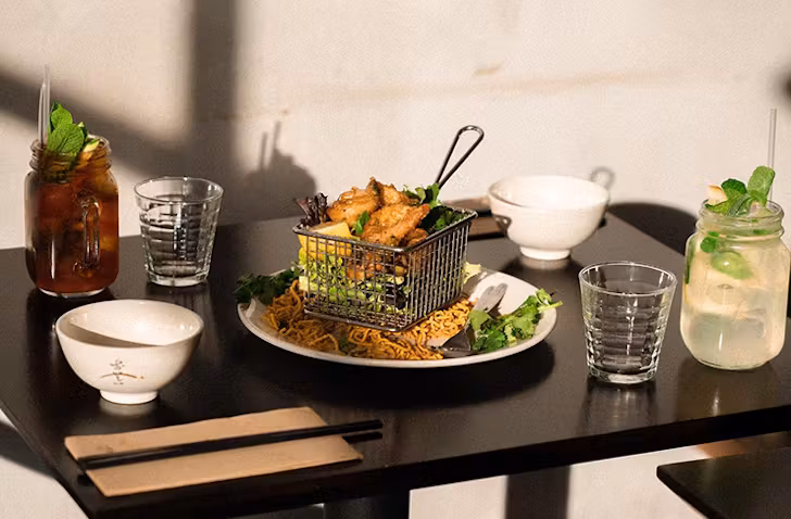 A table with food and two drinks at one of the best box hill restaurants called Tien Dat