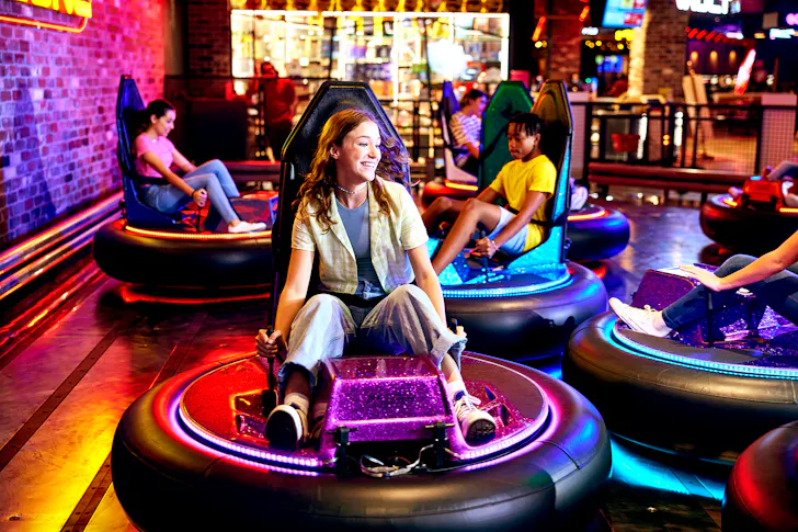 Woman playing bumper cars at Timezone. 