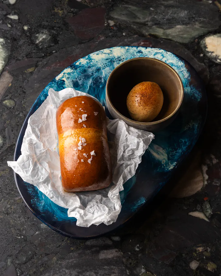 a plate of gelato with small bread rolls
