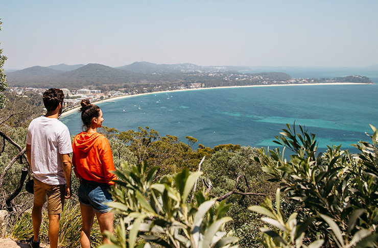 man and woman looking out over port stephens on mountain