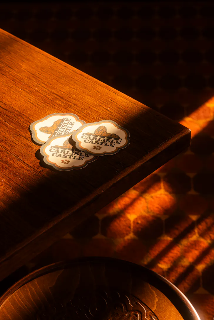 pub coasters on a table in the afternoon light
