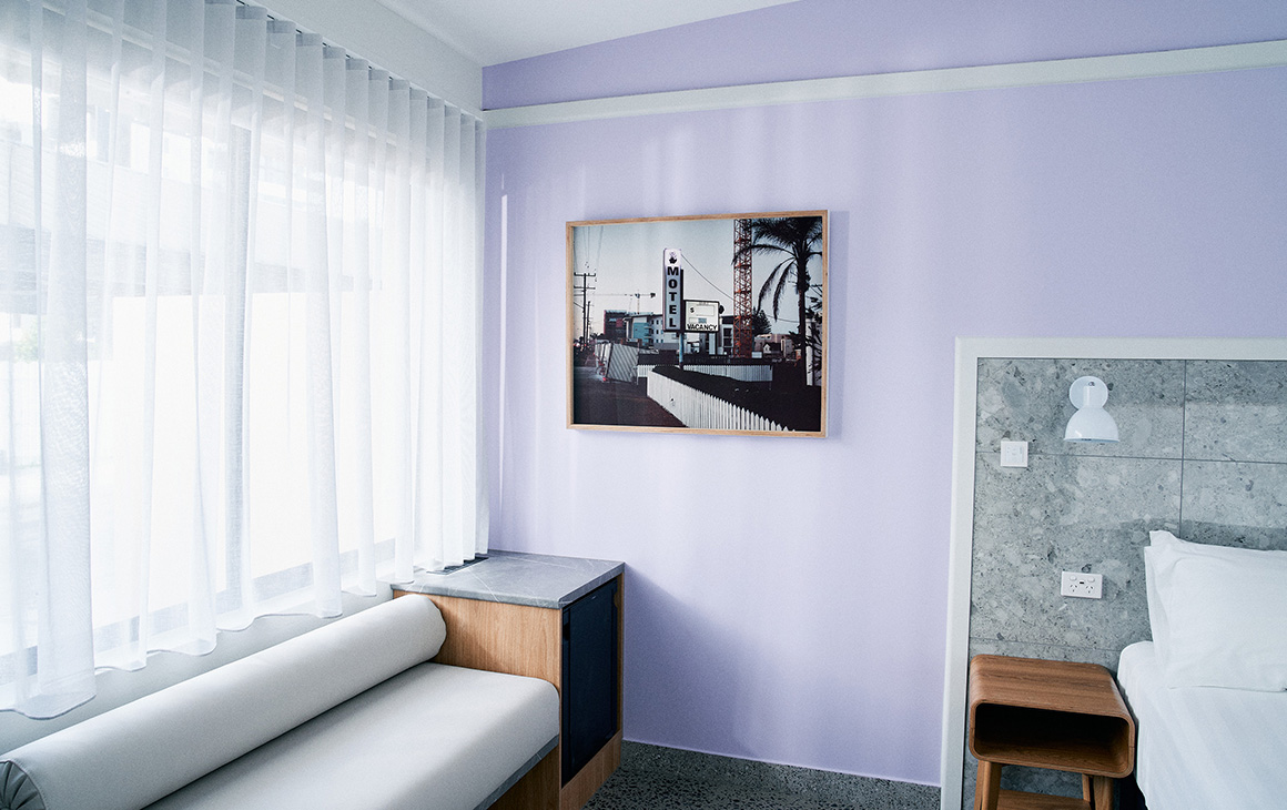 a purple interior of a room at The Mysa Motel