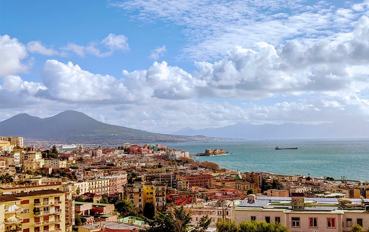 colourful houses line the beach in Naples