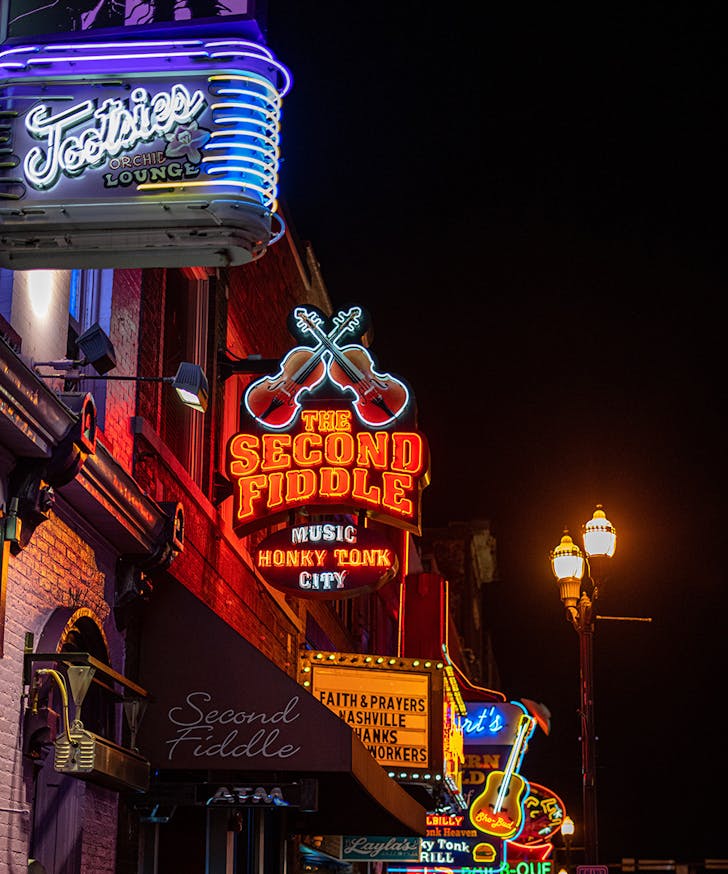 Neon signs line a street in Nashville