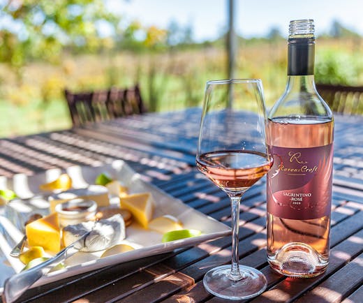 a bottle of rose and a cheese platter.