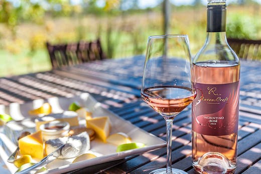 a bottle of rose and a cheese platter.