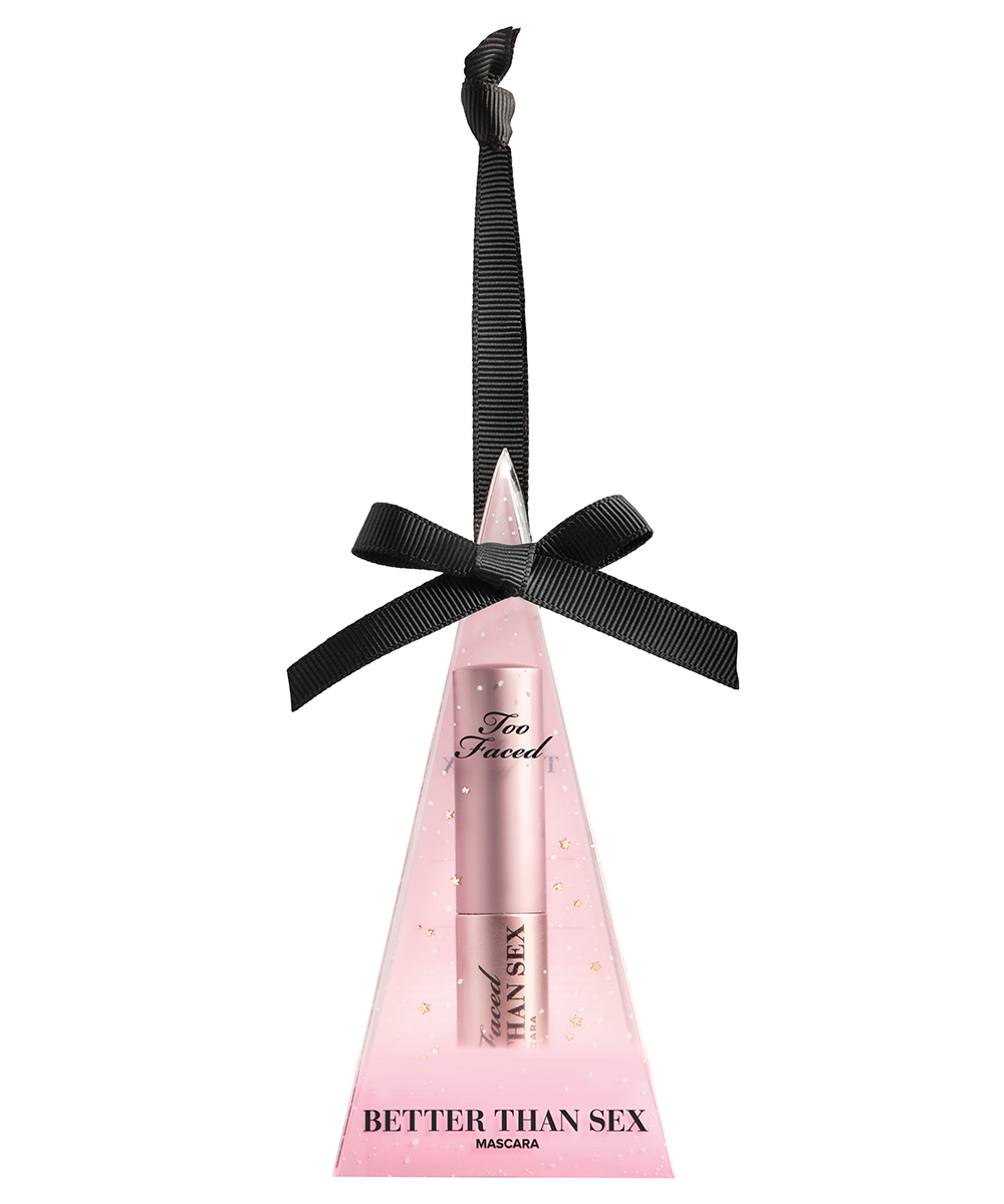 a pink Christmas ornament with a mascara inside.