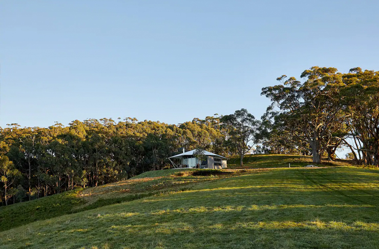 glamping style tent on grassy hill