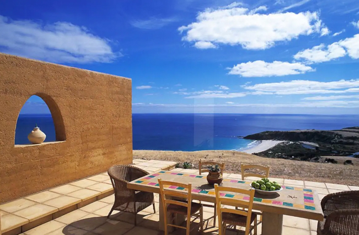 outdoor dining chairs on open air deck looking out to ocean