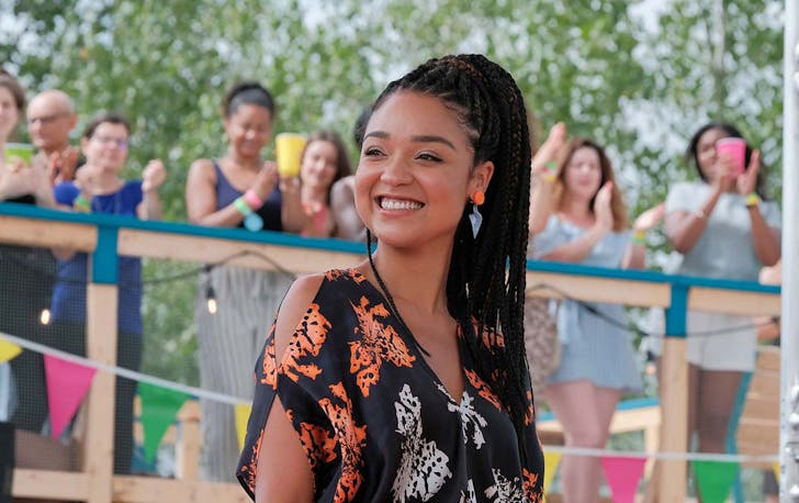 Aisha Dee as Kat on The Bold Type set smiles off camera.