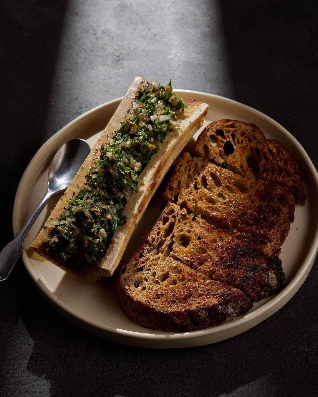 toast and bone marrow on plate