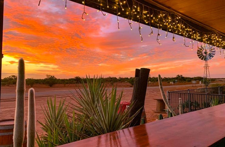 paddlesack roadhouse overlooking outback road at sunset