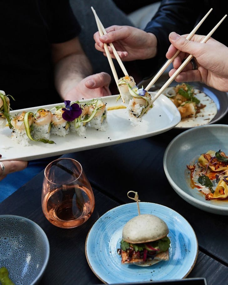 People sharing food at Azabu in Auckland. 