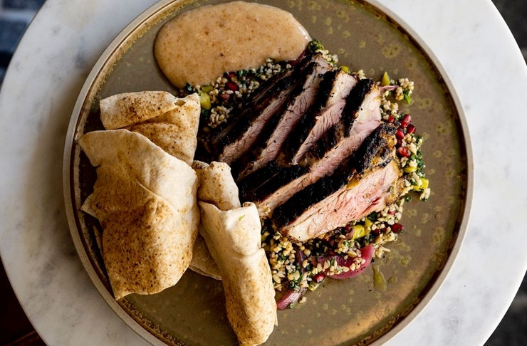 sliced meat and rolled bread on plate