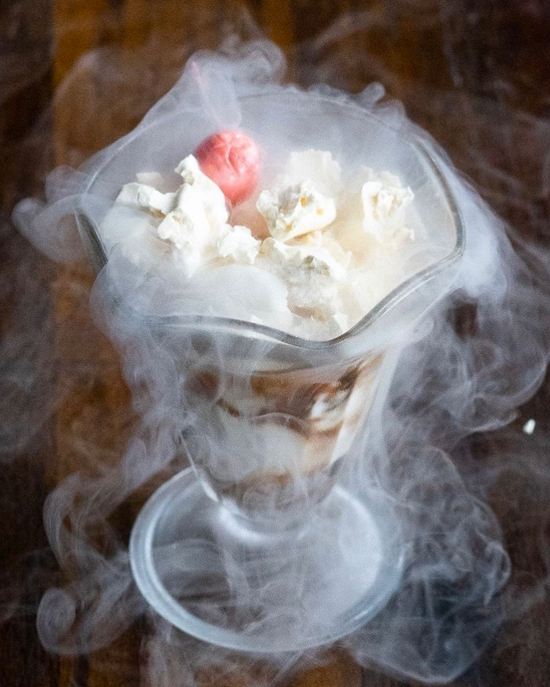 a smokey goblet filled with ice cream